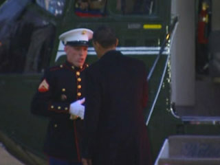 President Obama startles saluting Marine by reaching to shake his hand.