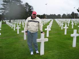 After 64 years, Bill Knudsen finally meets his father, Bill Cuthbert, at the latter's grave in the American cemetery in Normandy.